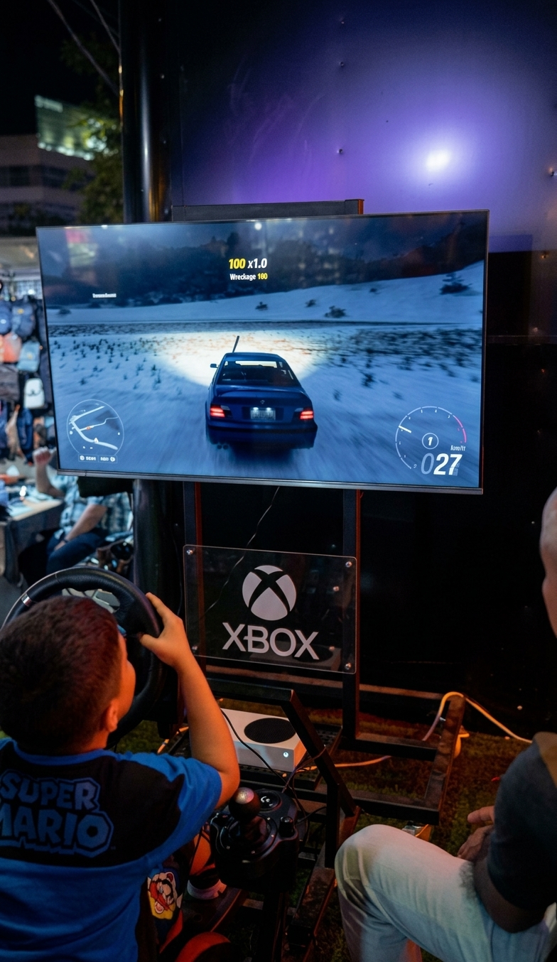 A young gamer playing a racing game on a wheel rig
